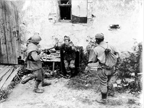 Two soviet soldiers taking a surrendering german during world war ll.