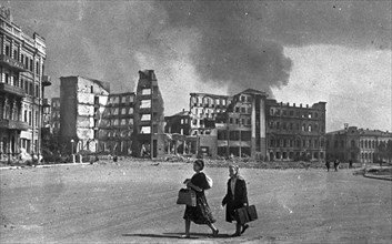 World war 2, battle of stalingrad, two women heading for safer ground while bombs drop on stalingrad.