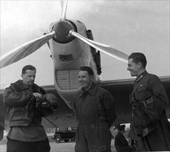 The crew of the ant 25-1, second plane to make a transpolar nonstop flight from the ussr to the usa in the summer of 1937, shown at the schelkovo airdrome near moscow, in front of their plane are (l t...