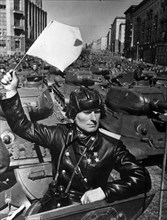 Tank officer and hero of the soviet union colonel sukhovarov leading the mechanized and armored units to red square during a may day parade in the early 1950s, t-34 tanks.