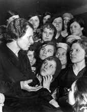 A group of workers at a moscow shoe factory listening to one of their members tell about the recent trial of members of the anti-soviet 'right-trotskyist bloc', convicted of betraying thier country, m...