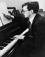 Soviet composer, dmitri shostakovich, working at his piano.