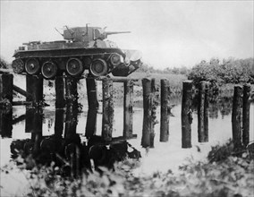 Soviet radio-equipped r-34 (?) light tank crossing a destroyed bridge during red army maneuvers, 1938.