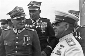 Marshals georgy zhukov and rokossovsky receive highest awards from the polish military, marshal m, rola-zymierski, commander-in-chief of the polish army, zhukov, and colonel-general s, poplawski at th...