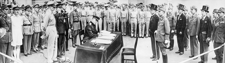 Leiutenant-general k,n, derevyanko, representative of the ussr, signing the act of japan's capitulation on board the american battleship missouri, 1945, general macarthur is at the microphone, to the ...