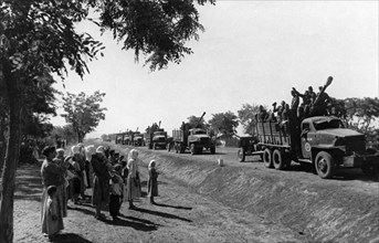 A column of soviet troops passing a group of romanian villagers during world war ll, september 1944, the trucks are american, sent as part of the lend-lease program.