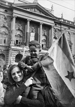 People on the streets of belgrade, yugoslavia during a celebration of the first anniversary of liberation from the germans.