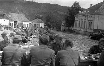 World war 2, soldiers of the (yugoslavian) national liberation army at a dinner arranged for them in the town of brus, december 1944.