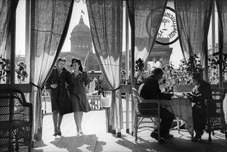 Two young women entering a cafe on 25th october prospect (nevsky prospect) in leningrad, may 1941.