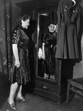 Nina lobkovskaya in war and peace, like all young girls, nina loves pretty clothes, here she is trying on a dress during a shopping trip, if it were not for her uniform with its decorations hanging ne...