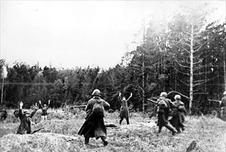 German soldiers who had been covering the retreat of their unit surrender after disclosed from a grove of woods by soviet red army men.