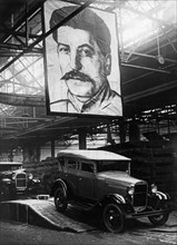 Automobiles (1929 ford type) leaving the assembly line of the molotov auto plant in gorky, ussr, 1930s.