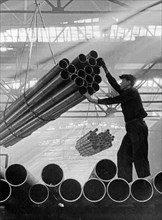 Ural industrial area, a worker handling finished products at the chelyabinsk pipe factory, this shop was completed and turning out finished products in the course of four months in 1942.