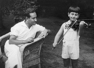 David oistrakh, professor of the moscow state conservatory and laureate of international contests, listening to the playing of his son at his country residence near moscow, september 1938.