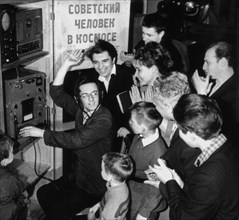 People joyfully listening to the news of the successfull landing of the first man in space, soviet cosmonaut yuri gagarin in 1961.