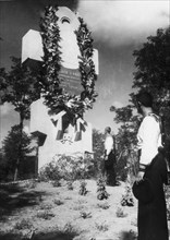 Soviet sailors paying their respects at the monument to russian soldiers killed during the defense of the russian fortress at port arthur in 1904 during the russo-japanese war, the picture was taken i...