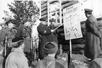 world war ll: soviet army men and commanders studying a plan for attack on an enemy iron and concrete fort.
