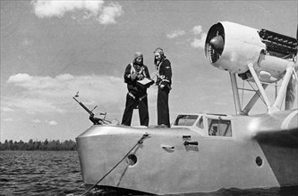 Northern fleet, soviet naval reconnaissance plane pilot, captain vereshchagin (left) with his navigator, mapping out their route before take-off, july 1942.