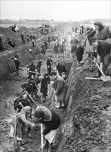 world war ll: moscovites and inhabitants of moscow suburban villages digging an anti-tank ditch.