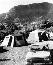 Tourists camping by smolian lake in the rhodope mountains, bulgaria, may 1974.
