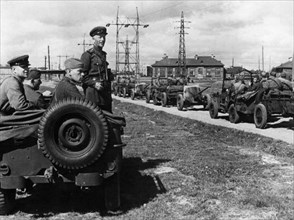 A commander of a soviet tank destroyer unit watching the column pass,the american jeeps, sent as part of the lend-lease program, were very popular with the russians, world war ll.
