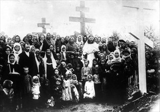 The widows and children of the massacred lena goldfield workers at a funeral service at the common grave in 1912.