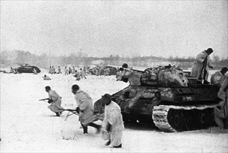Red army troops dislodge germans from the village 'n' on the western front, soviet t-34 tanks and red army infantry advancing on german positions during winter fighting on the western front.
