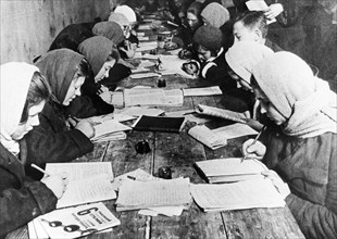 A basic literacy class given at the club of the krasny bogatyr works (factory) in moscow, 1932.