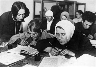 Soviet women being taught to read and write during a literacy drive in the early 1930s, ussr.