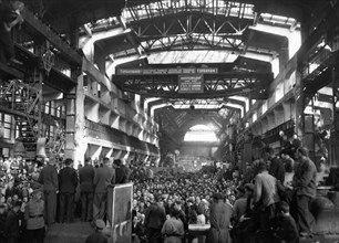 A post-war meeting of workers at the kirov factory discussing plans for production necessary to complete the five-year-plan in four, this factory has been decorated three times, leningrad, ussr, 1946.
