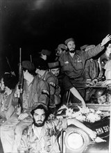 Newly victorious fidel castro ruz entering havana at the head of his revolutionary army, cuba, 1959, juan almeida bosque is behind him in profile.