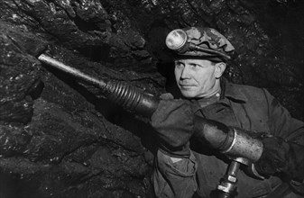 Soviet miner grigory nyrobtsev at work in the lenin coal mine in the molotov region, ussr, 1947.