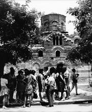 A group of foreign tourists visiting a medieval church in nessebre, bulgaria, 1974.