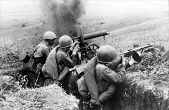 Machine-gunners firing at the germans during battle for a height in the northern caucasus during world war ll, 1942.