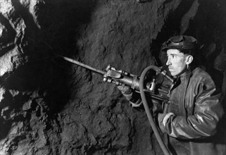 Chapai sozayev working in a mine in the 'krasnaya shapochka' (red riding hood) bauxite bed in the northern urals, ussr, 1947.