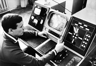 Luna 21 mission, an operator preparing the equipment for communication traffic, working at the controls of the soviet remote-controlled lunar rover, lunokhod 2 at the distant space communications cent...