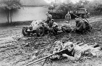 The crew of an anti-tank gun in the northern caucasus taking a strategic position, fires at enemy tanks which attempt to break through to the village.