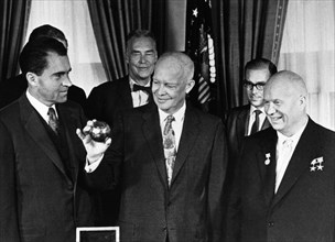 Nikita khrushchev with president dwight d, eisenhower and vice-president richard m, nixon at the whitehouse on september 16, 1959, khrushchev just presented the president with a copy of the pendant th...