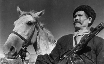 60 year old cossack pavel kamnev of the guards corps commanded by lieutenant-general kirichenko, kamnev, together with his two sons, volunteered to fight the hitlerite invaders, in an engagement near ...