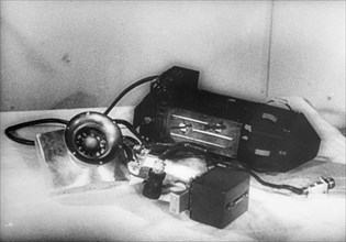 A photo electric device and multiplier controlling the use of batteries used in sputnik 2, the larger device is the other radio transmitter, while the satellite was in the shadow of the earth, electri...