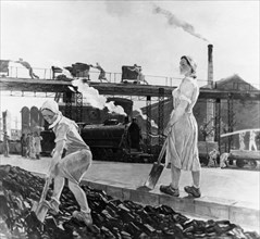 Soviet socialist realism, painting of heroic women workers shoveling coal in a rail yard, ussr, 1950s.