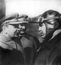 J,v, stalin and sergo ordzhonikidze talking with soviet flyer v,p, chkalov at moscow central airdrome, may 1935.