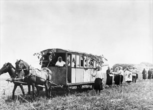 Mobile nurseries like this one accompany women collective farmers in the fields during the busy harvest season (1930s), ussr.