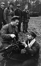 Partisans in western byelorussia being taught to fire a heavy machine-gun, world war 2.