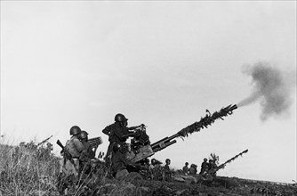 Defense of the ham zhong bridge, a north vietnamese anti-aircraft artillery emplacement fighting off an american air attack, 1966.