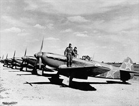 World war 2, soviet air force yakovlev yak-9d fighters lined up on an airfield, the squadron guards the new u,s, bases for aircraft landing in the soviet union.