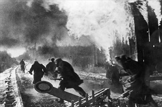 World war 2, russian partisans behind enemy lines setting fire to a freight train at a german supply depot.