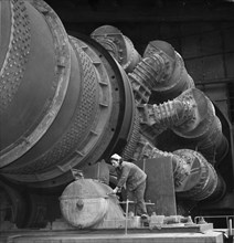 Woman working on a furnace in the 'vulkan' cement plant, 1964.