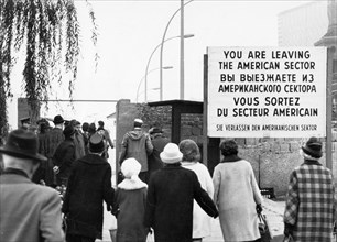 West berliners crossing over at the oberbaum checkpoint to visit relatives in east berlin in accordance with a recently signed treaty allowing such visits, october 1964.
