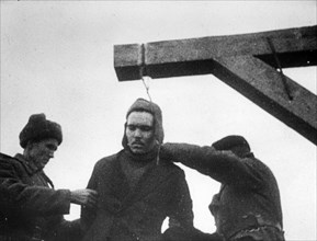 World war 2, december 19, 1943, still from a film on the kharkov trial produced by artkino, noose being placed around the neck of the russian traitor, mikhail petrovich bulanov.